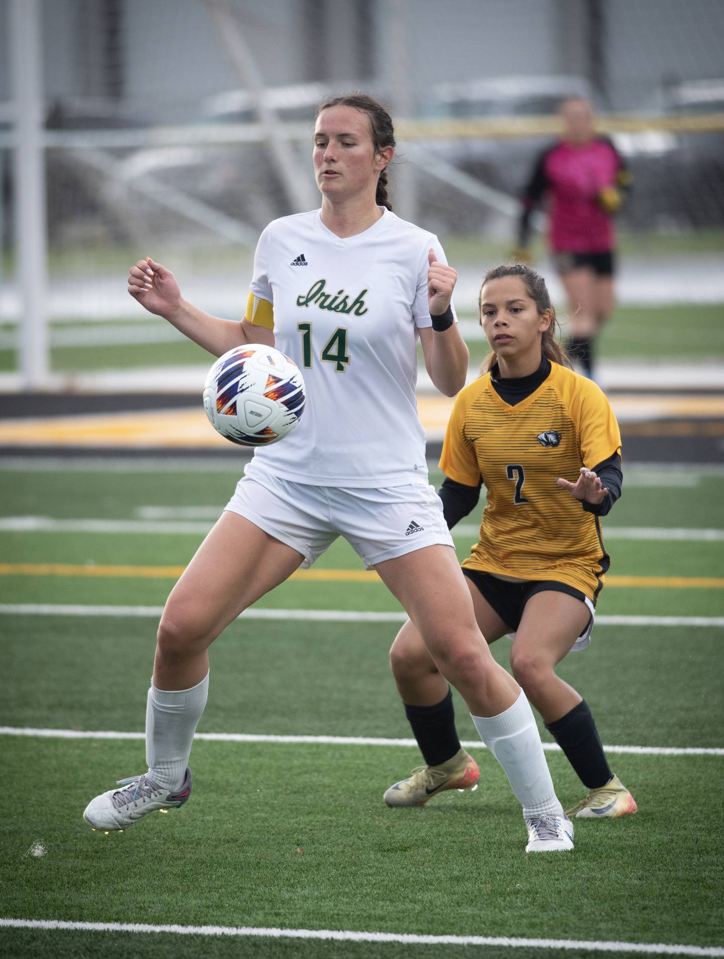 Bishop McNamara's Ella Langellier plays the ball as Herscher's Adraina Flores defends in a regional championship game on Tuesday, May 20, 2025.