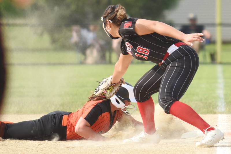 Minooka's Addisonn Crumley, left, safely dives back to first base as Bradley-Bourbonnais' Leila Middlebrook applies a tag during the Class 4A Normal Community West Sectional semifinals Tuesday, June 3, 2025.