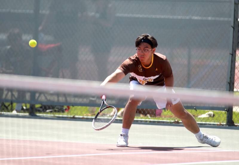 Carmel’s Louis Vu returns the ball during a doubles match with partner Evan Vilinski (not pictured) in the state championship preliminaries at Palatine High School on Thursday, May 23, 2024.