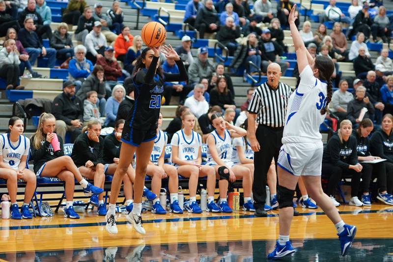 St. Charles North's Sydney Johnson (20) shoots a 3-pointer against Geneva’s Keira McCann (30) during a game at Geneva High School on Thursday, Dec. 4, 2025.