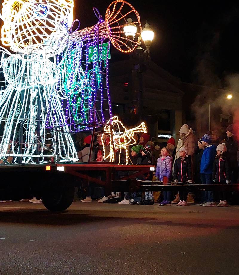 Parade goers gaze at the lighted floats making their way down La Salle Street on Friday, Nov. 24, 2023, during the Festival of Lights in Ottawa.