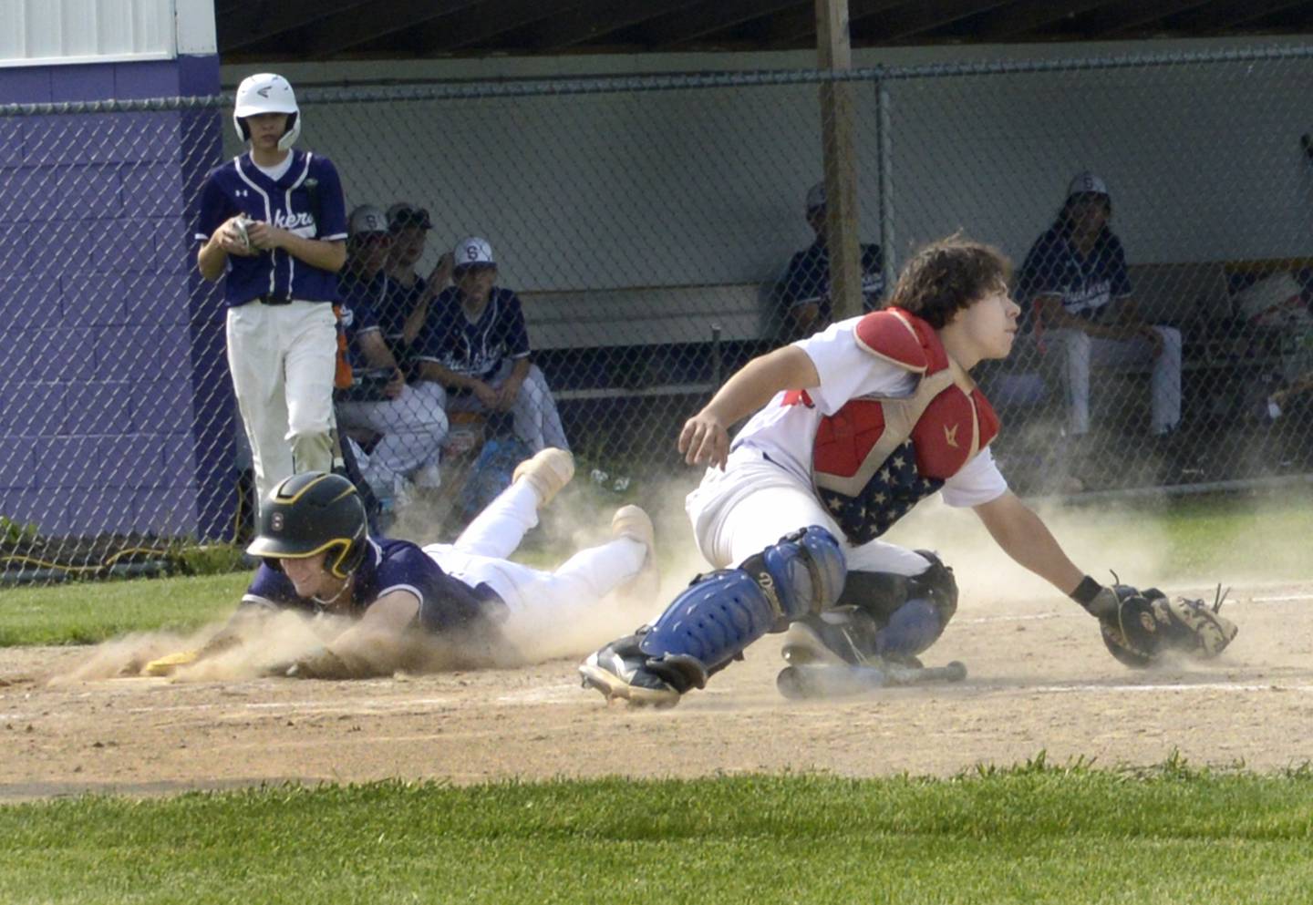 Serena Carson Baker beats the throw home to score as Yorkville Christian’s Jess Seaton awaits the the throw Thursday at Serena.