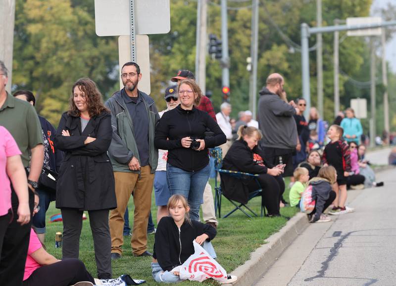 People wait for the start of the DeKalb High School homecoming parade on Dresser Road Wednesday, Sept. 27, 2023.