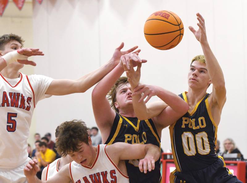 Polo's Aidan Messer (24) and JT Stephenson (00) reach for the ball as they battle Oregon's Tucker O'Brien (5) and Landon Anderson (4) for a rebound on Friday, Dec. 5, 2025 at the Blackhawk Center in Oregon.