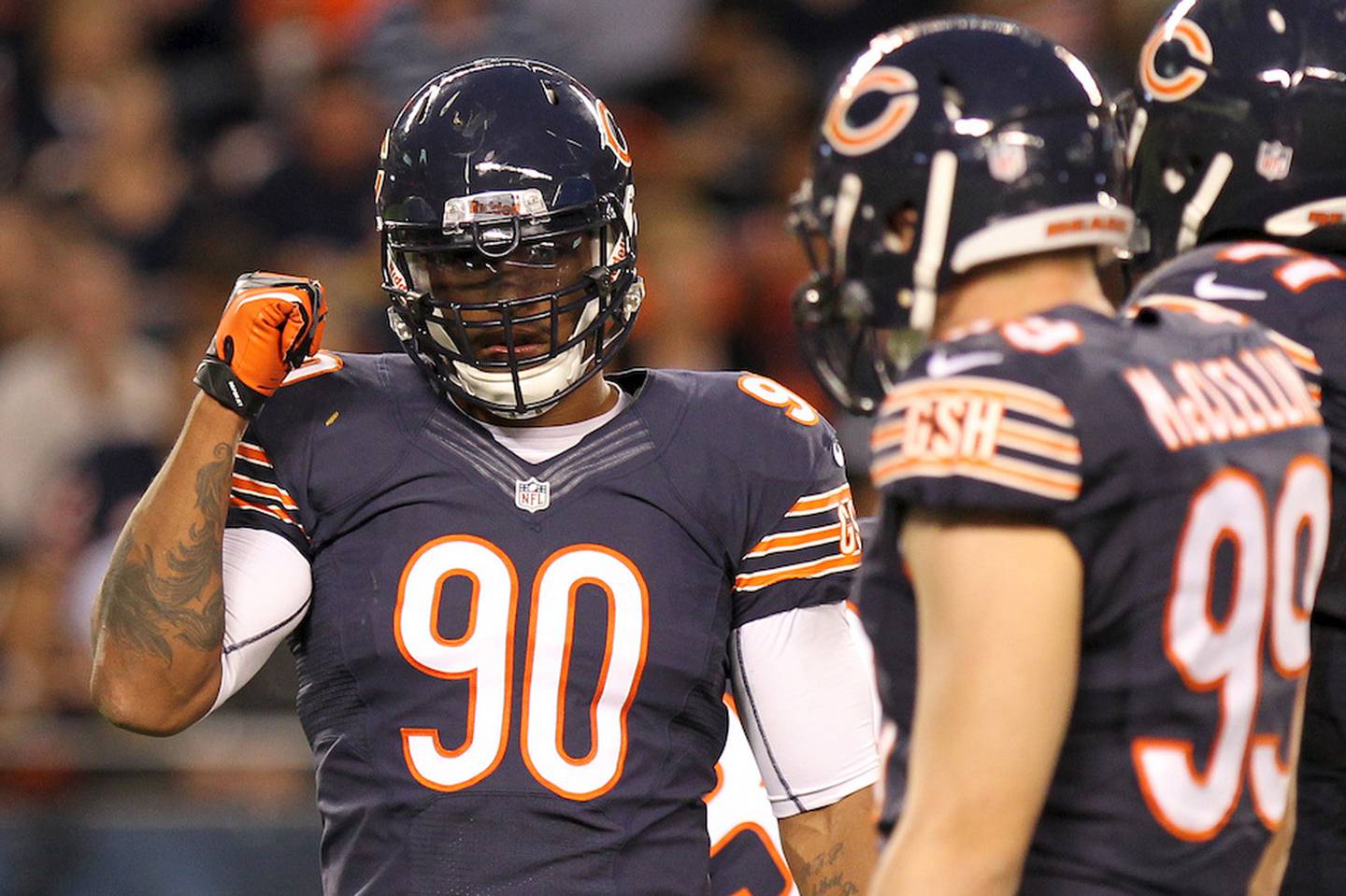 Then-Chicago Bears defensive end Julius Peppers signals to the defense during a preseason game against the Washington Redskins August 18, 2012 in Chicago. Peppers signed with the Green Bay Packers this offseason.