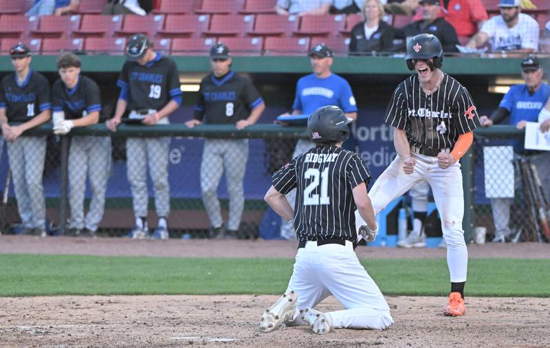 St. Charles East’s Cole Ridgway and teammate Joey Arend celebrate after they both scored in the third game of an inter-city series against St. Charles North at Northwestern Medicine Field in Geneva on Tuesday, April 20, 2024.