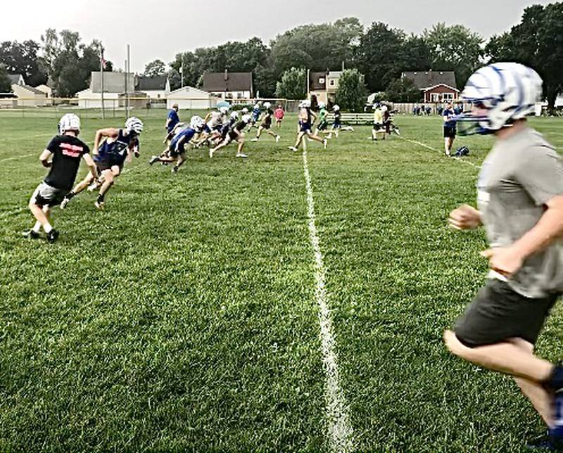 The Tigers run the 12-minute shuttle at the end of Monday morning's practice at Little Siberia.