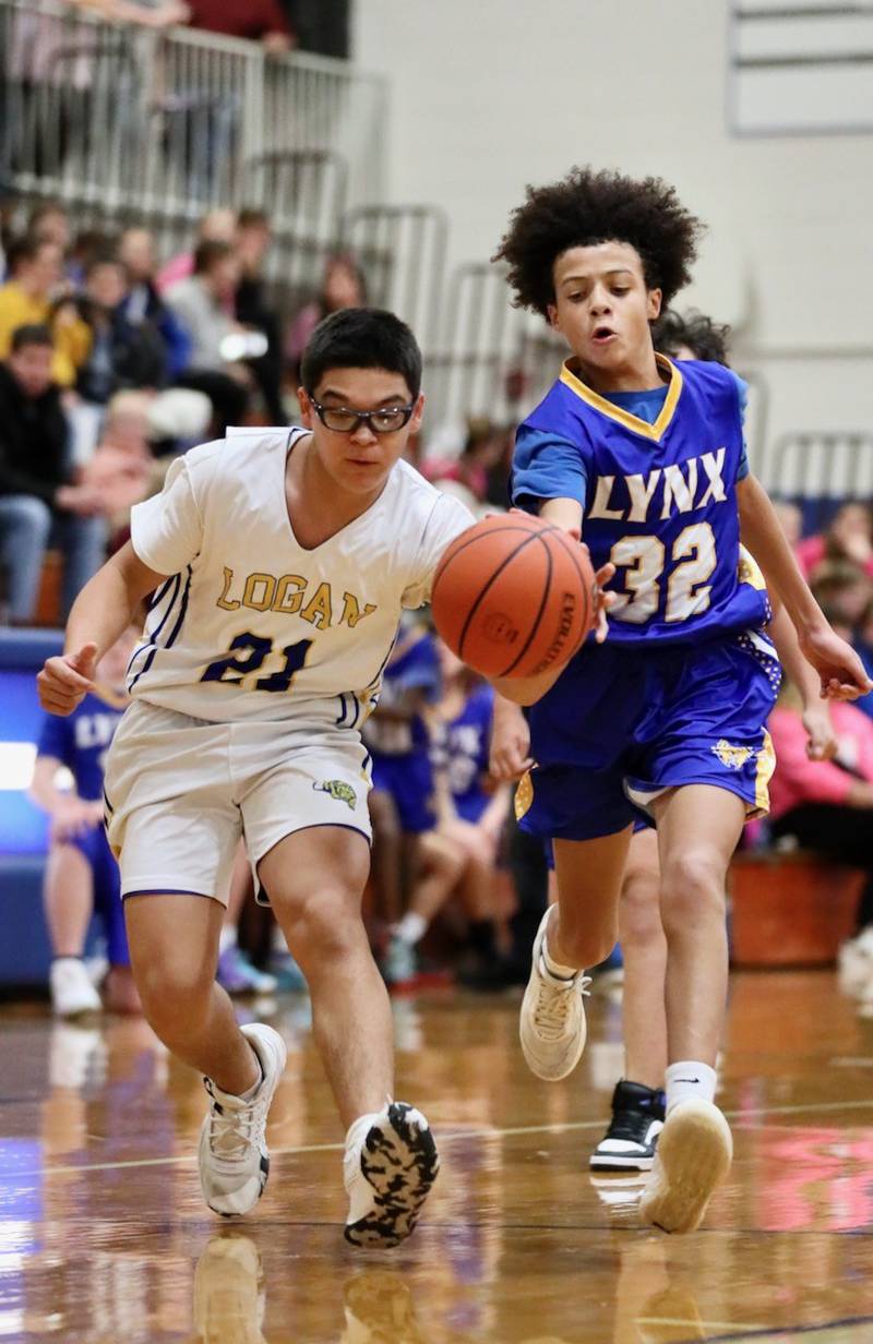 Logan eighth-grader Tristan Salazar battles for the ball during Tuesday's Fight like Erin Night at Prouty Gym against LaSalle Lincoln.