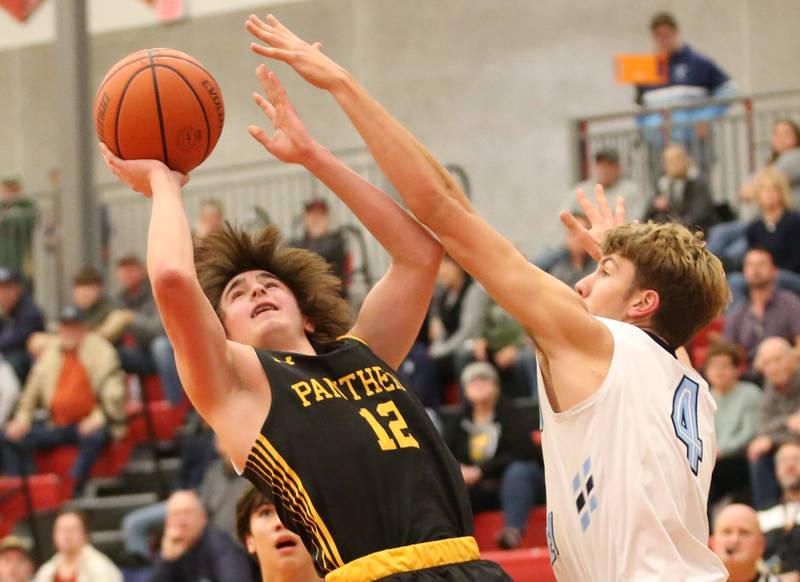 Putnam County's Gavin Cimei eyes the hoop as Bureau Valley's Landon Hulsing defends during the 49th annual Colmone Class on Thursday, Dec. 7, 2023 at Hall High School.