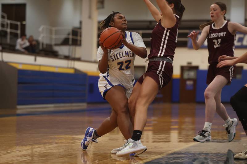 Joliet Central’s Alexi Bradley draws the foul driving to the basket against Lockport.