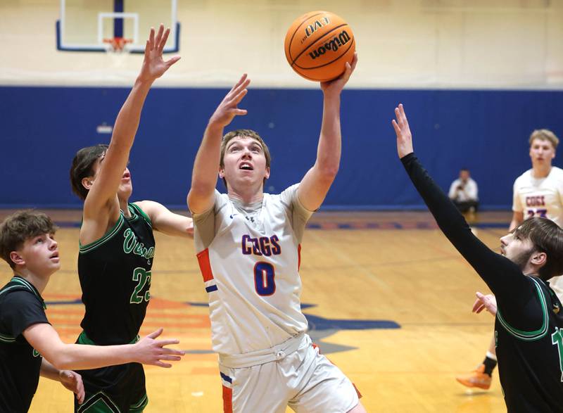 Genoa-Kingston's Nathan Kleba drives between three North Boone defenders during their Class 2A regional game Monday, Feb. 24, 2025, at Genoa-Kingston High School.