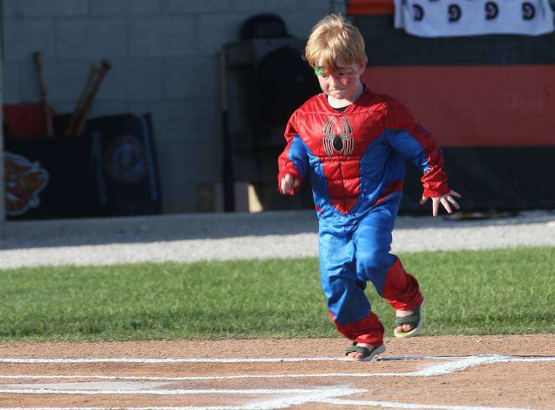 Greg Sarver III darts for home plate while wareing his Spider Man costume during the Illinois Valley Pistol Shrimp Halloween in July on Wednesday, July 23, 2025 at Schweickert Stadium in Peru. The event featured a Trick or Treat Scavenger Hunt presented by Peru Federal Savings Bank, Pregame Performance from the Hocus Pocus Hags and a kids costume parade.