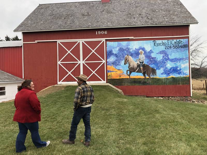 Rancho El Calate owner Roberto Antunez, left, and mural artist Melissa Wallace talk Wednesday, Nov. 24, 2021, about the recently completed mural at the ranch outside Ringwood.