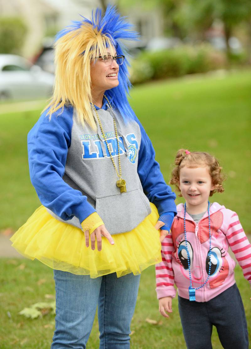 Lyons Township High School counselor Tammy Miller of Brookfield brings the spirit watching from the sidelines with her kids watching the annual homecoming parade on Saturday, Sept. 24, 2022.