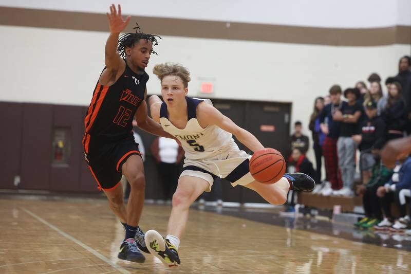 Lemont’s Rokas Castillo drives around Romeoville’s Troy Cicero Jr. in the WJOL Thanksgiving Classic Championship in Joliet on Saturday.