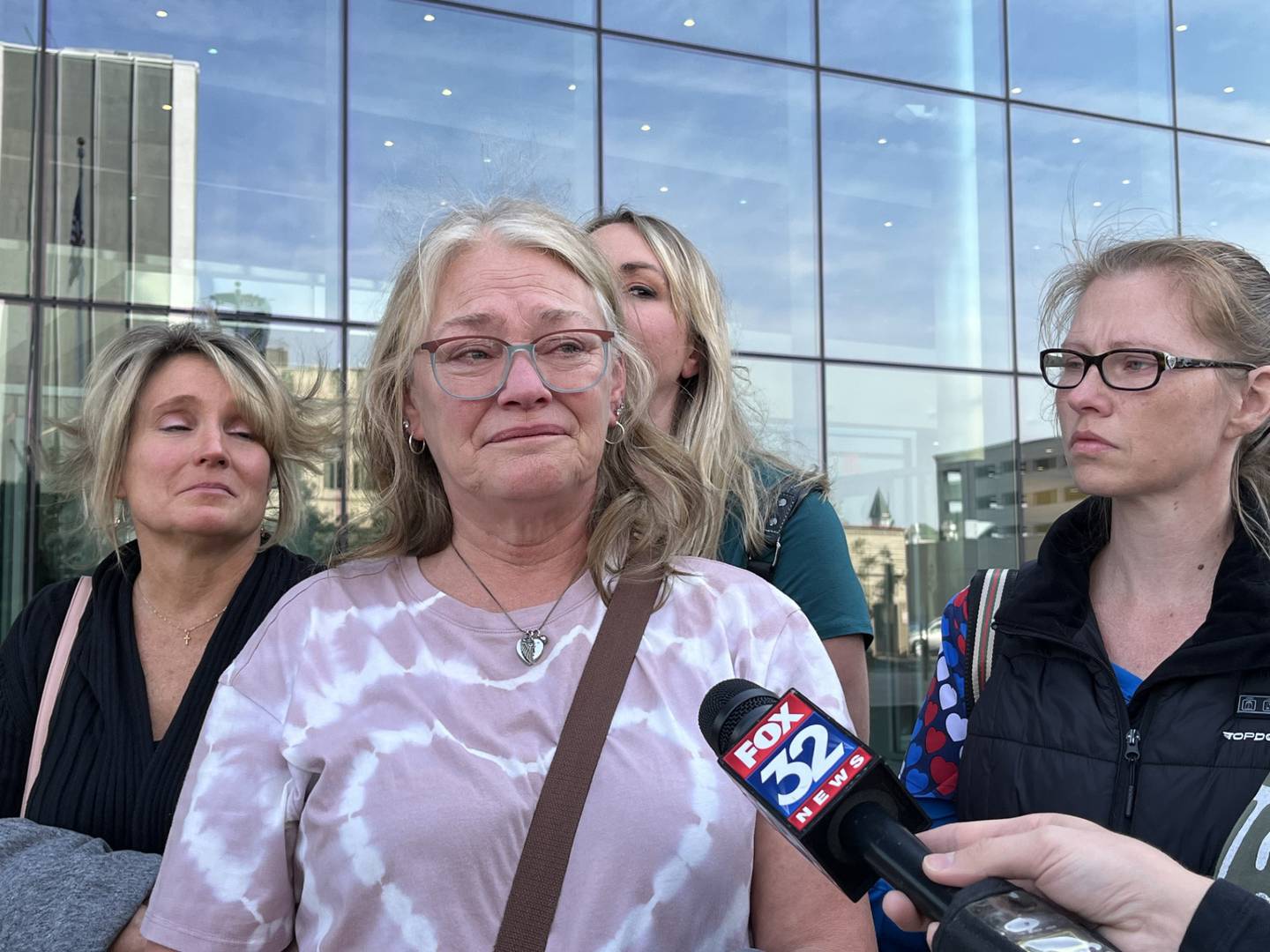 Shirley Onderisin (center), mother of Ashtin Eaton, 32, and grandmother of 14-month-old Hazel Bryant, said speaks with reporters on Friday Oct. 11, 2024, outside the Will County Courthouse in Joliet.