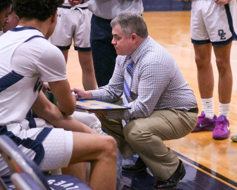 Oswego East's head coach Ryan Velasquez talks to the team between quarters while taking on Yorkville High School on Friday Feb. 14, 2025, Held at Oswego East High School.