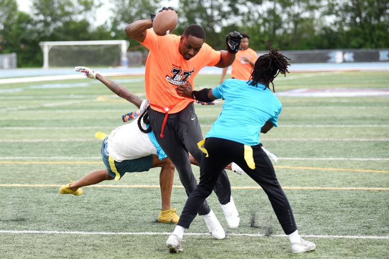 Malcolm White looks to evade a pair of flag-pullers during a game of 7-on7 at the sixth annual Jonathan Ward Skills Camp at Kankakee High School Saturday, June 14, 2025.