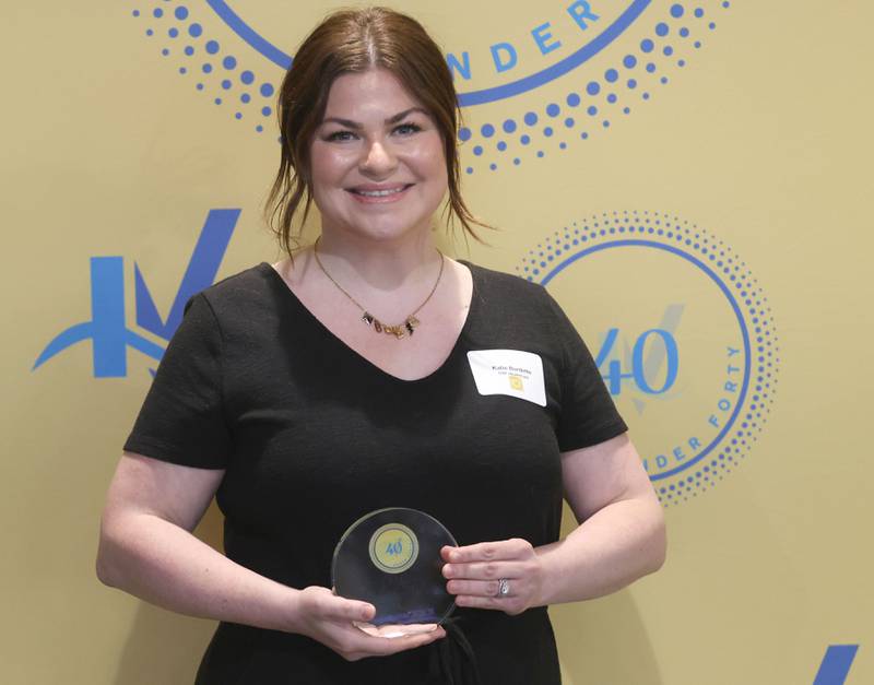 Katie Burdette poses with her 40 Under Forty award during the Illinois Valley Chamber of Commerce Champions of Change Awards Night on Wednesday, May 6, 2026 at the Westclox Event Center in Peru.