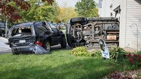 Driveway collision causes parked car to crash into house in Wonder Lake