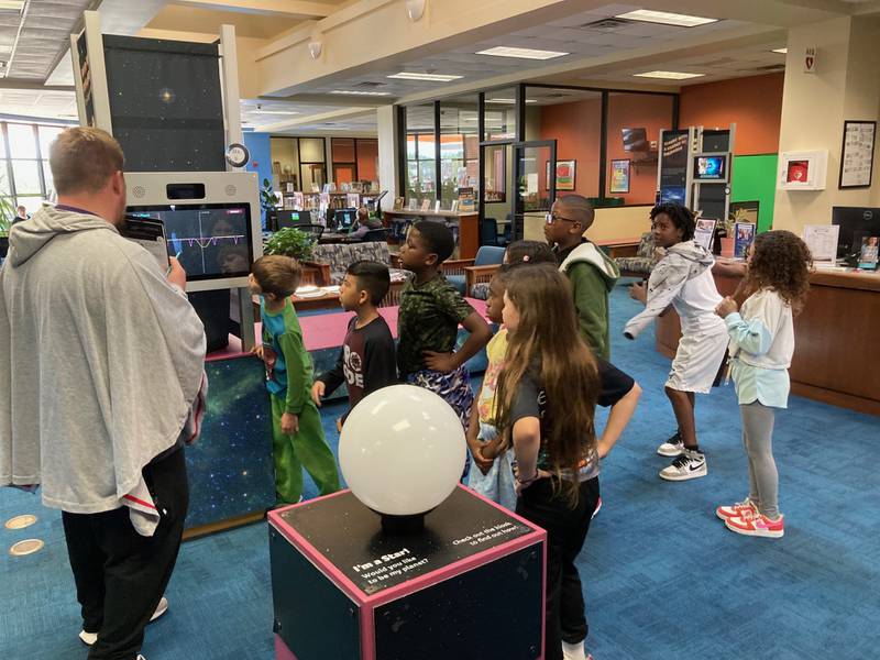 Children view the "Discover Exoplanets: The Search for Alien Worlds," an exhibit coming to the Joliet Public Library in December and made possible by a grant from NASA. Oct. 25, 2024