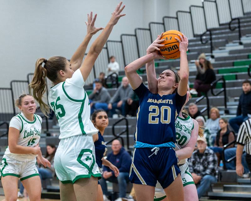 Marlie Lisssy (25) of Seneca guards Kaitlyn Davis (20) of Marquette as she shoots ball and gets blocked by Gracie Smith (20) of Seneca on Monday, November 17, 2025 at Seneca High School in Seneca.