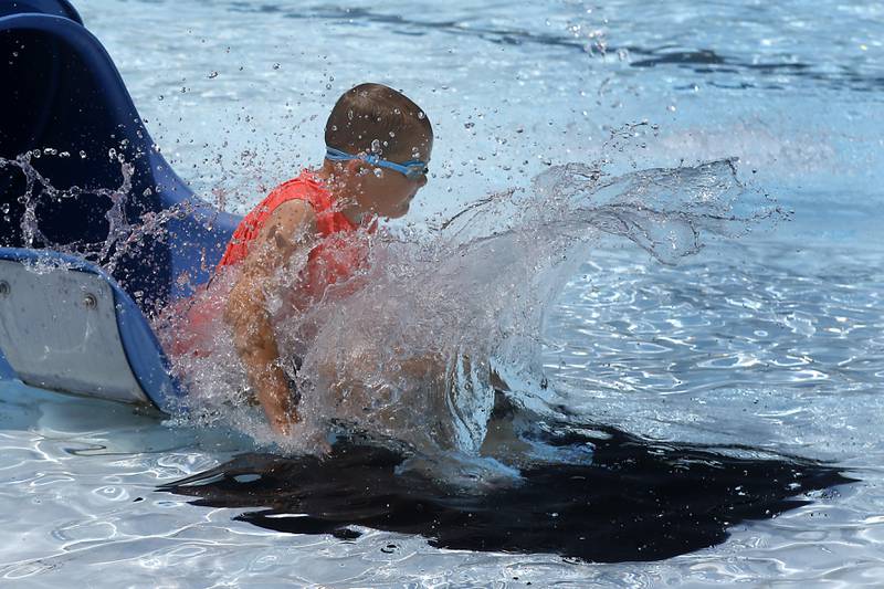 Jarrod Appel, 9, makes a big splash as he goes down a slide while swimming on Friday, June 21, 2024, at Woodstock Water Works.