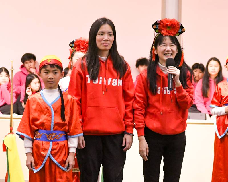 Teacher Li Lijuan, right, is all smiles as she announces former student Lin Lin Yuzhe and her son Huang Zherui who is a current student of the Jjong Jheng Elementary School Suona and Drum Ensemble from Kinmen, Taiwan, durring the demonstration portion of the performance on Saturday April 19, 2025, held at the Taiwanese American Chamber of Commerce building in Westmont.