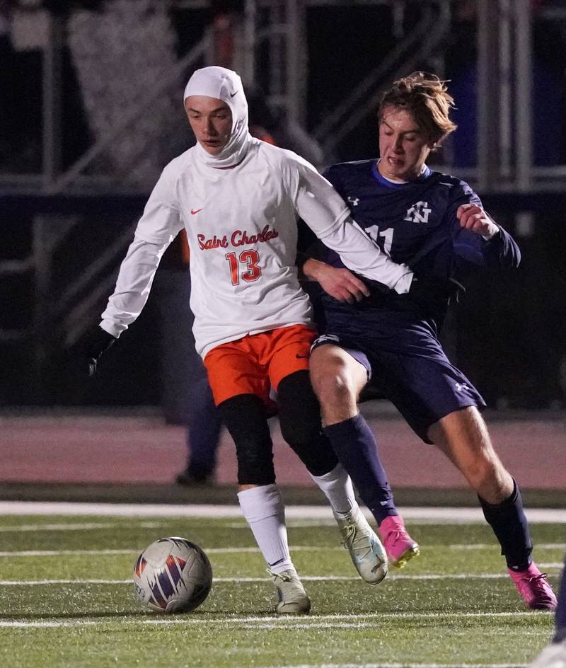 St. Charles East's Connor Sychowski (13) plays the ball against New Trier's Cole Driscoll (11) during the class 3A St. Charles North Boys Soccer Supersectional match at St. Charles North High School on Wednesday, Nov. 1, 2023.