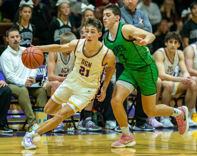 Downers Grove North's Jack Stanton (21) drives to the basket against York's A.J. Levine (3) during a basketball game at Downers Grove North High School on Friday, Dec 9, 2022.