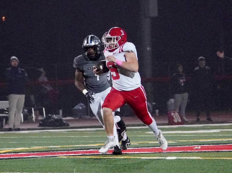 Yorkville's Michael Dopart (9) carries the ball on a keeper against Oswego East during a football game at Yorkville High School on Friday, Oct. 13, 2023.