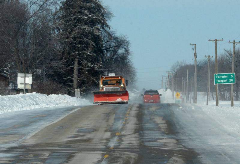 An Illinois Department of Transportation snow plow spreads salt on Route 64 between Mount Morris and Route 26 on Monday, Jan. 15, 2024 as temperatures plunged to below zero throughout the day.