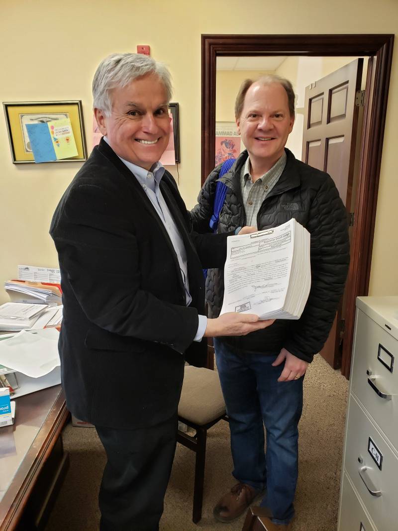John Duggan, an attorney from Park Ridge, (left) and Kane County Judge John Noverini with the judge's nominating papers for the Illinois Supreme Court Second Judicial District GOP primary. Noverini filed nearly 4,500 signed petitions at the Illinois Board of Elections in Springfield on Monday.