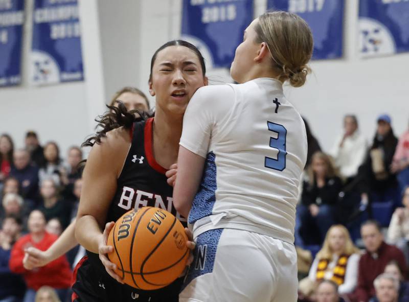 Benet's Emma Briggs (24) tries to drive through Nazareth's Lyla Shelton (3) during a girls varsity basketball game between Benet and Nazareth academies on Saturday, Dec. 14, 2024 in La Grange Park.