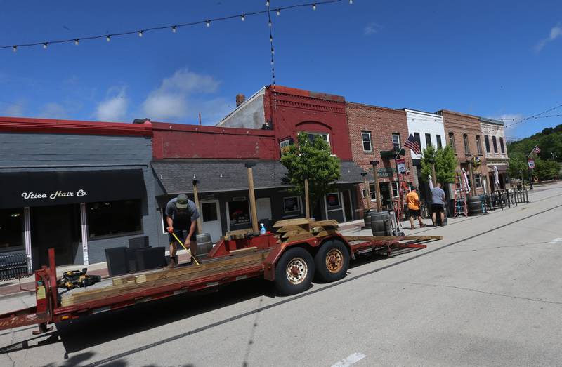 Crews begin to set up tables and chairs on Mill Street on Tuesday, May 7, 2024 downtown Utica. Mill Street has been closed to motorists once again as tables, chairs and other patio furniture can be placed for the outdoor dining experience.