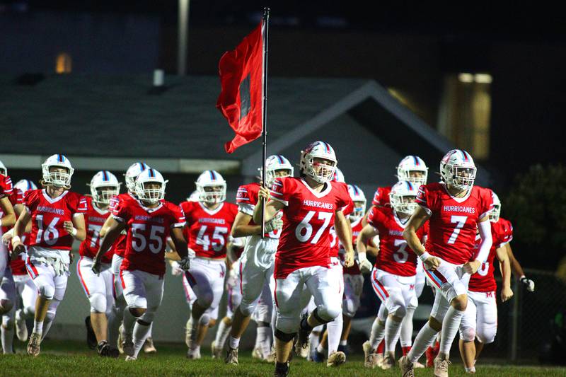 Marian Central’s Hurricanes take the field to face Chicago Hope in varsity football at Woodstock Friday night.