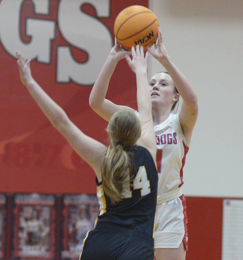 Streator’s Ava Gwaltney tries to get this shot away from the block of Herschel’s Audrey Hoffman n the 1st period Tuesday at Streator.