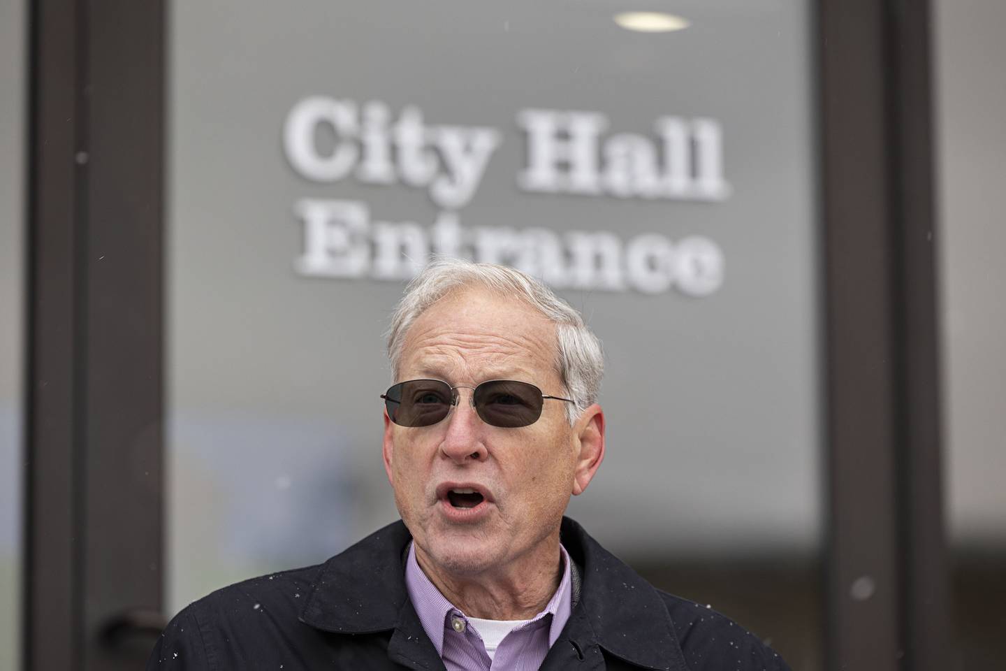 Surrounded by friends, family and supporters, Glen Hughes announces his candidacy for Dixon mayor Friday Nov. 18, 2022 on the steps of city hall. Hughes is a retired bank executive with many years of community service.