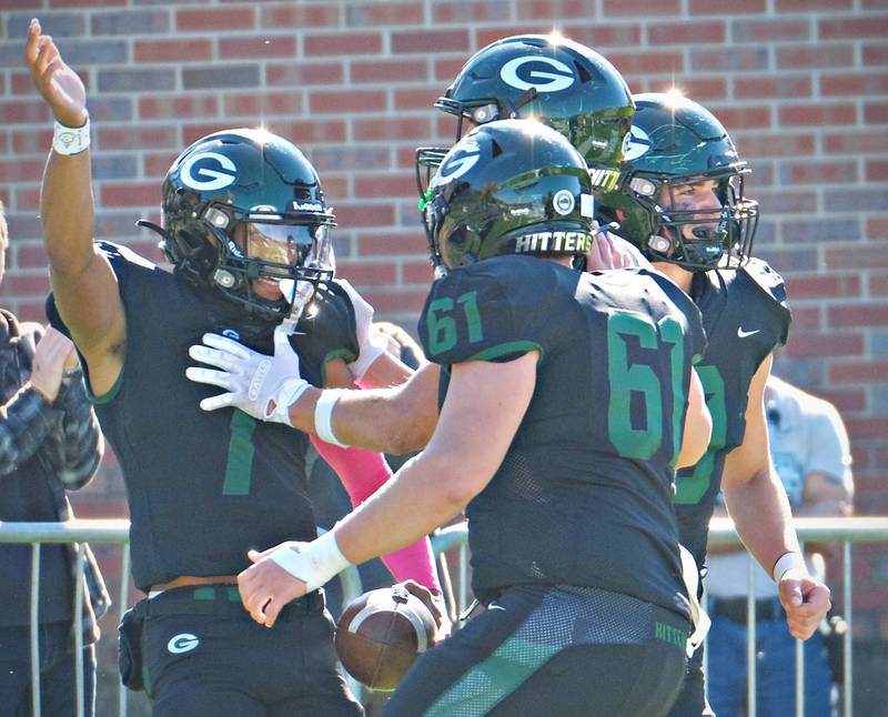 Glenbard West's Korey Tai (7) celebrates with teammates after scoring on a quarterback keeper play during an IHSA Class 8A playoff game against Lockport on Oct. 29, 2022 at Glenbard West High School in Glen Ellyn.