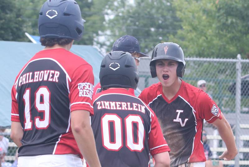 Spring Valley's Logan Philhower, Cade Zimmerlein and Jaxon Pinter react after scoring a run against Burbank during the Central Regional Senior Baseball Regional tournament at J.A. Happ Field in Washington Park in Peru.