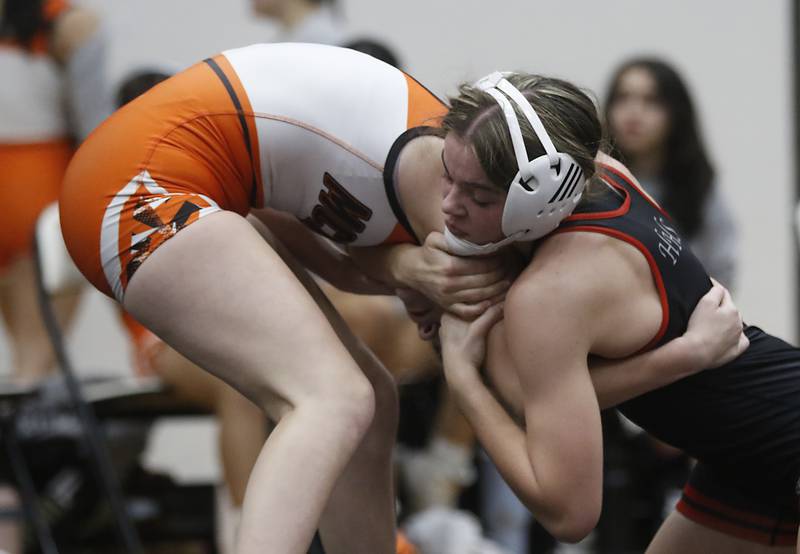 Huntley’s Aubrie Rohrbacher tries to control McHenry’s Mackensie Hendricks during the 130-pound match of a Fox Valley Conference girls wrestling match Thursday, Jan. 11, 2024, at McHenry High School.