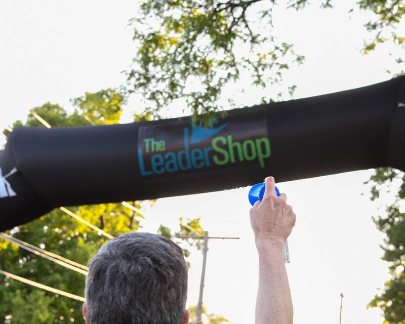 Board member, Treasure and chairman of the Leadershop 5k event Jim Hinckley of La Grange sounds the airhorn signifying the start of the 5k on Friday June 9, 2023.