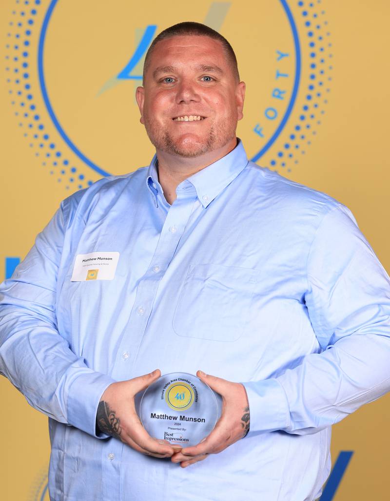 Matthew Munson poses with his 40 Under Forty award during the Illinois Valley Chamber of Commerce Champions of Change Awards Night on Thursday, April 10, 2025 at the Westclox Event Center in Peru.