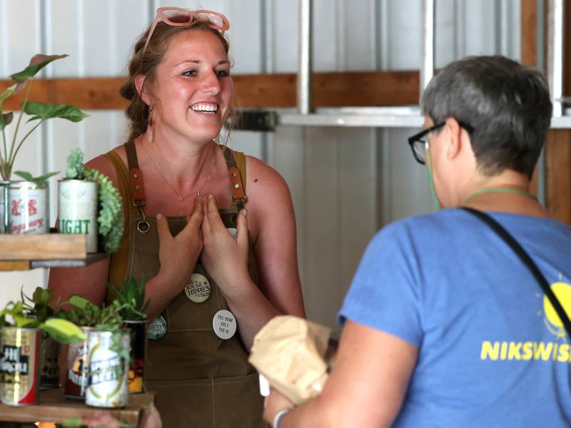 Amanda Mathey, from Sycamore, helps a customer at her Stoney Willows booth Tuesday, June 3, 2025, during the the Sycamore Farmers Market, hosted by Kar-Fre Flowers and Gifts. The market will be held Tuesdays from 3-6 p.m. through August 26 at Kar-Fre Flowers. Some of the market was held indoors due to the weather.