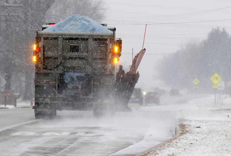 A snowplow salts the North Walkup Road north of Route 176 in Crystal Lake Thursday, Dec. 22, 2022, as a winter storm hits northern Illinois.