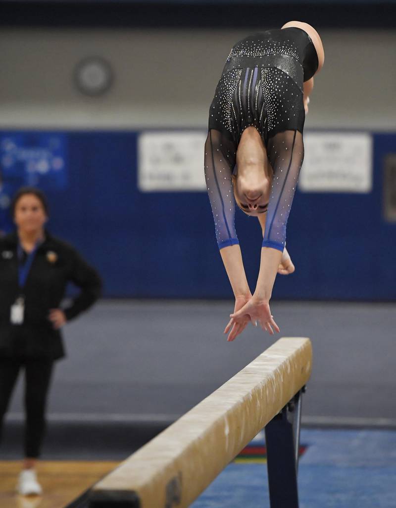 Geneva’s Reese Lackey performs on the balance beam at the Geneva girls gymnastics regional meet in Geneva on Wednesday, February 1, 2023.