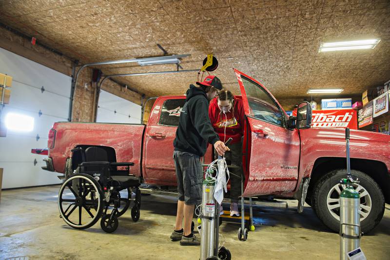Carlie Hamburg, 21, is helped out of a vehicle by husband Brandon Friday, Jan. 28, 2022 in Dixon. Just weeks after their Sept. 18 wedding Carlie was admitted the ICU at Kishwaukee Hospital with COVID related issues. After 4 months and three hospitals, Carlie returns home.