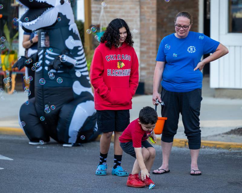 Kid picks up candy thrown from the annual Princeton Halloween Parade on Saturday, Oct. 4, 2025 on Main Street in Princeton.