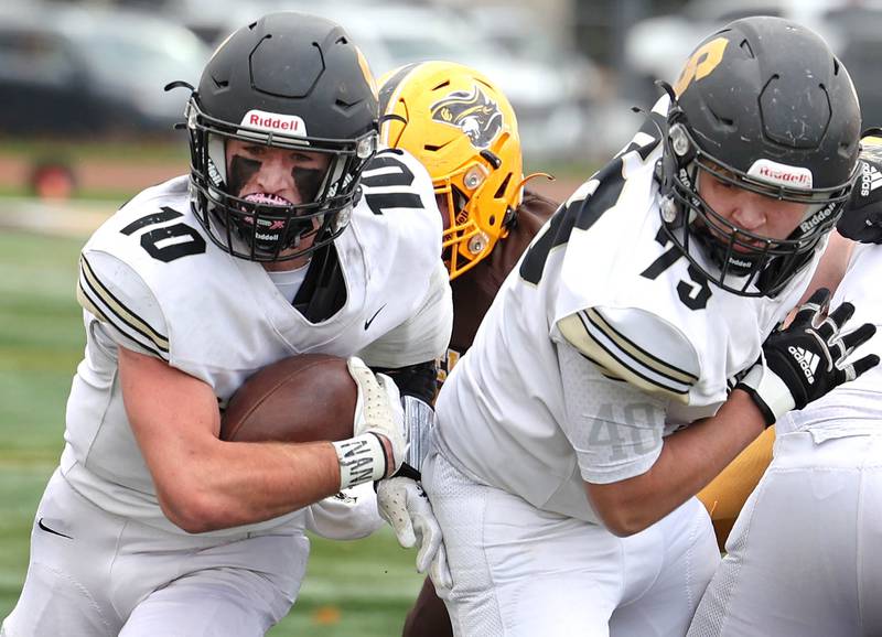 Sycamore's Zack Crawford follows the blocking of Brandon Coon during their Class 5A second round playoff game against Carmel Saturday, Nov. 5, 2022, at Carmel Catholic High School in Mundelein.