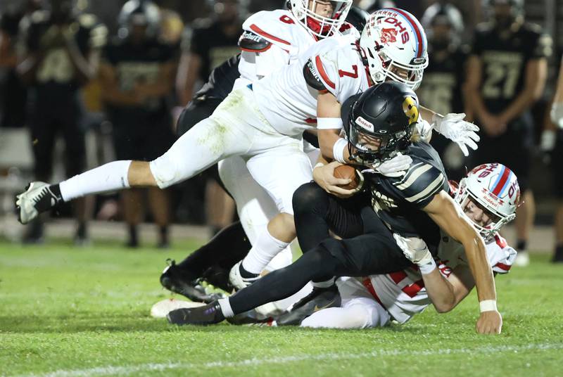 Ottawa's Dillan Quatrano brings down Sycamore's Elijah Meier during their game Friday, Sept. 16, 2022, at Sycamore High School.